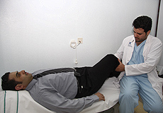 a physiotherapist assisting a patient with some therapy in knee