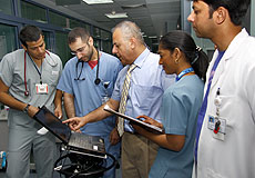 a group of doctors checking the Computerized Physician Order Entry (CPOE)