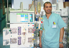 a male nurse standing next to the vital signs machine